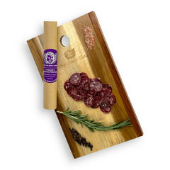 Venison & Berkshire Pork Salami sliced and presented on a gourmet charcuterie board, showcasing the rich, lean protein and artisanal natural casing.