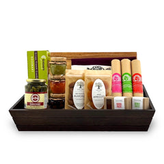 A gourmet charcuterie gift basket containing an assortment of dried fruits, nuts, spreads, olives, and salami, presented in a handcrafted wooden box with a knife and a cutting board.