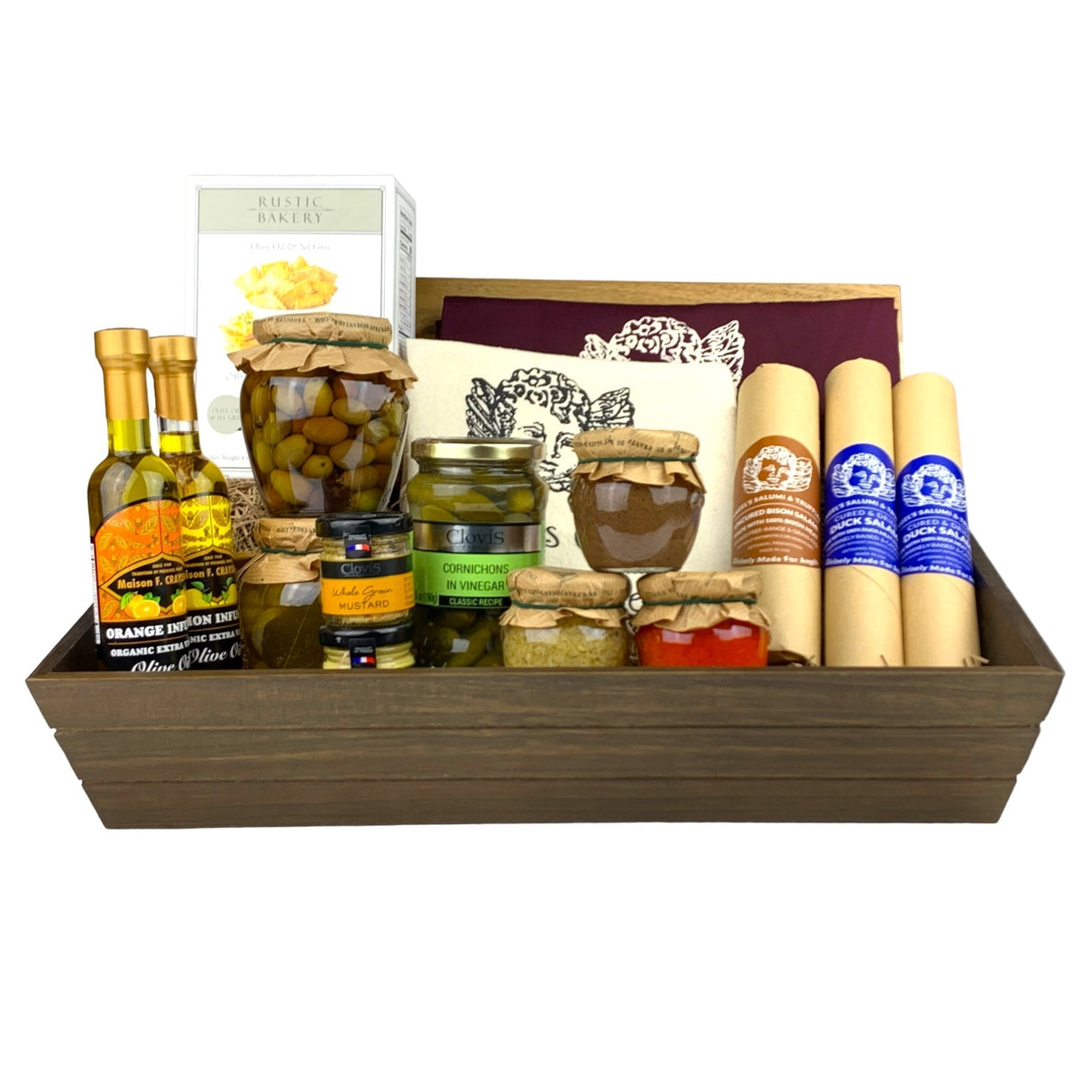 A dark wooden gift box filled with various antipasti and salami