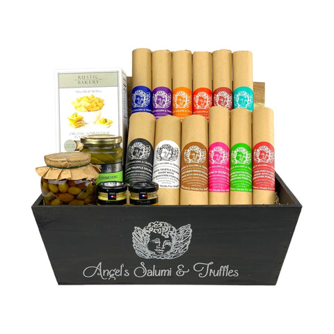 A dark wooden gift box filled with various antipasti and salami