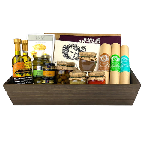 A dark wooden gift box filled with various antipasti and salami