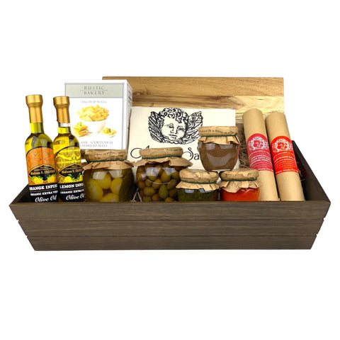 A dark wooden gift box filled with various antipasti and salami
