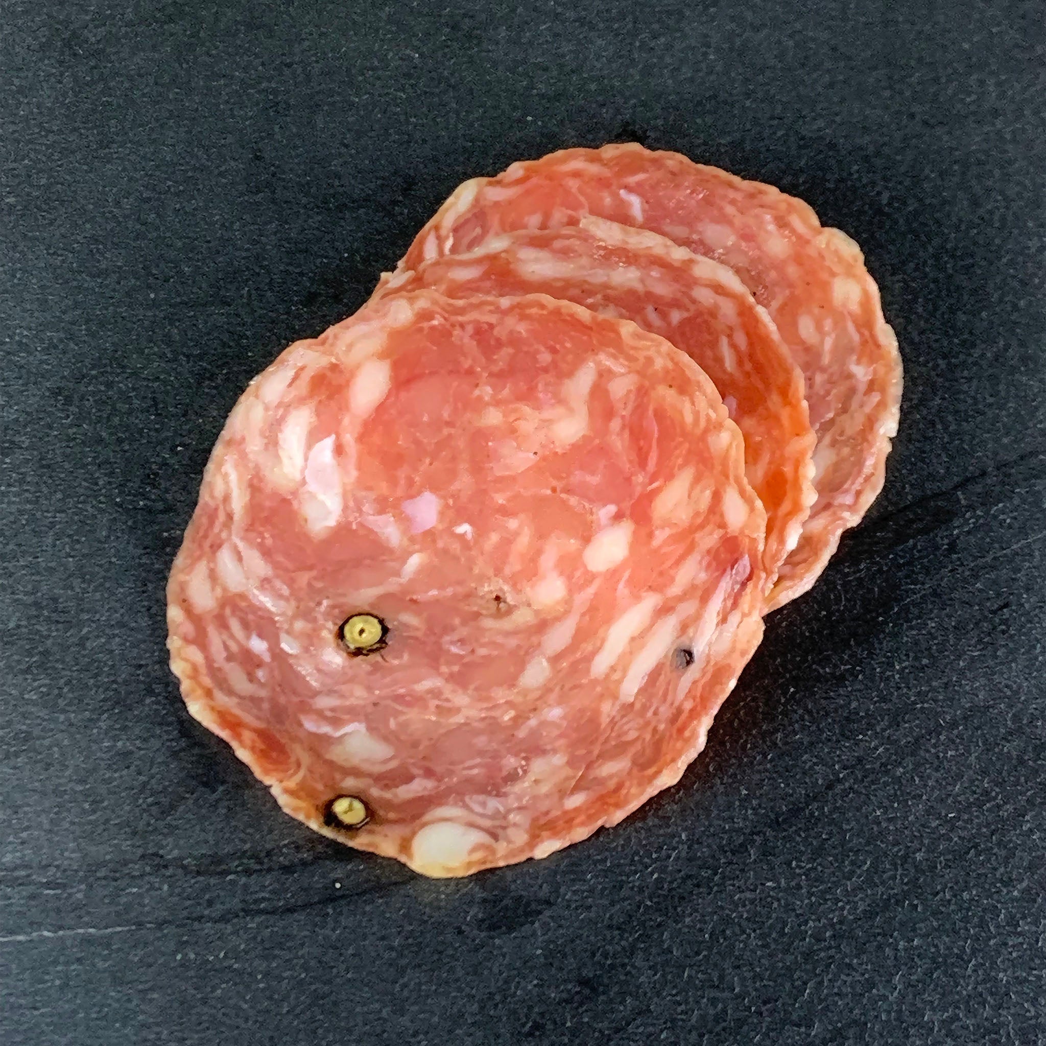 detail shot of sliced tosacno salami